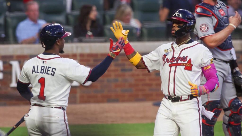 Sep 22, 2025; Atlanta, Georgia, USA; Atlanta Braves right fielder Ronald Acuna Jr. (13) celebrates with second baseman Ozzie Albies (1) after a home run against the Washington Nationals in the first inning at Truist Park.
