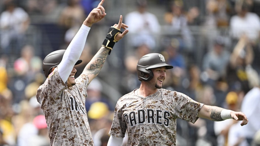 Sep 28, 2025; San Diego, California, USA; San Diego Padres third baseman Manny Machado (13), left, and Jackson Merrill (3) celebrate after scoring during the first inning against the Arizona Diamondbacks at Petco Park.