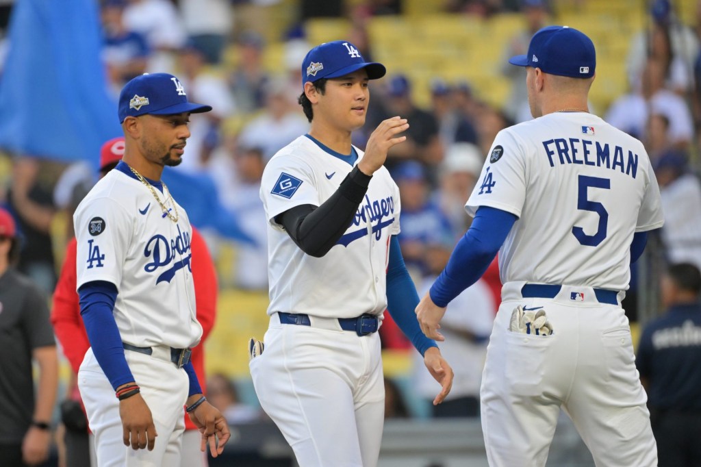 Sep 30, 2025; Los Angeles, California, USA; Los Angeles Dodgers designated hitter Shohei Ohtani (17) greets Los Angeles Dodgers first baseman Freddie Freeman (5) before the game against the Cincinnati Reds during game one of the Wildcard round for the 2025 MLB playoffs at Dodger Stadium.