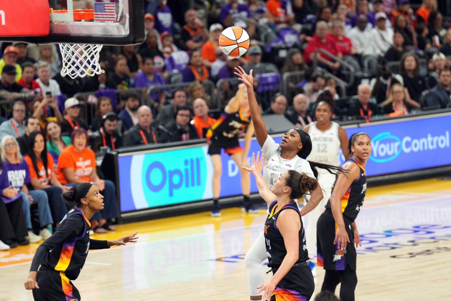 Oct 10, 2025; Phoenix, Arizona, USA; Las Vegas Aces guard Dana Evans (11) shoots against the Phoenix Mercury during the first half of game four of the 2025 WNBA Finals at Mortgage Matchup Center.