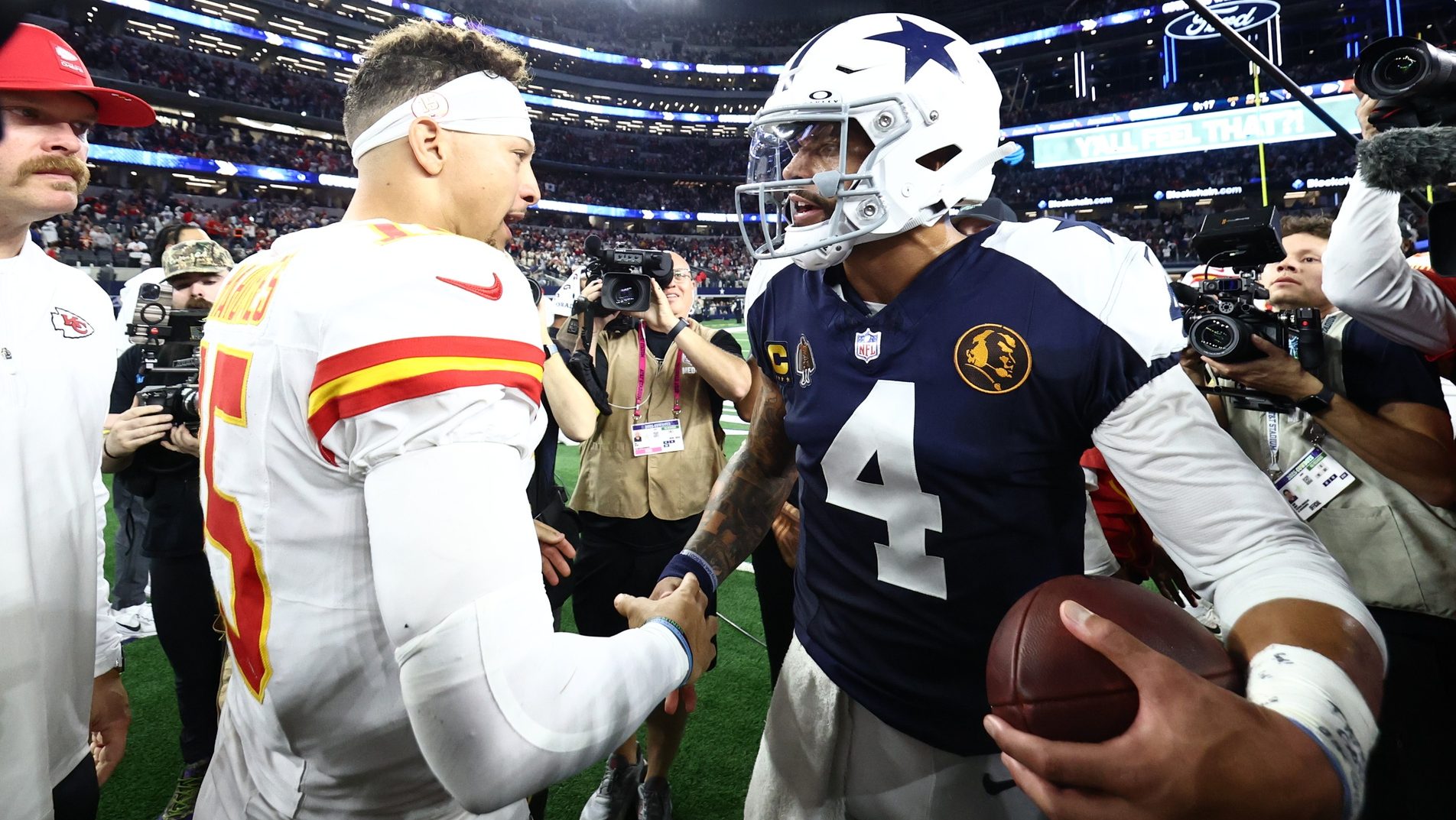 Nov 27, 2025; Arlington, Texas, USA; Kansas City Chiefs quarterback Patrick Mahomes (15) and Dallas Cowboys quarterback Dak Prescott (4) greet each other after the game at AT&T Stadium.