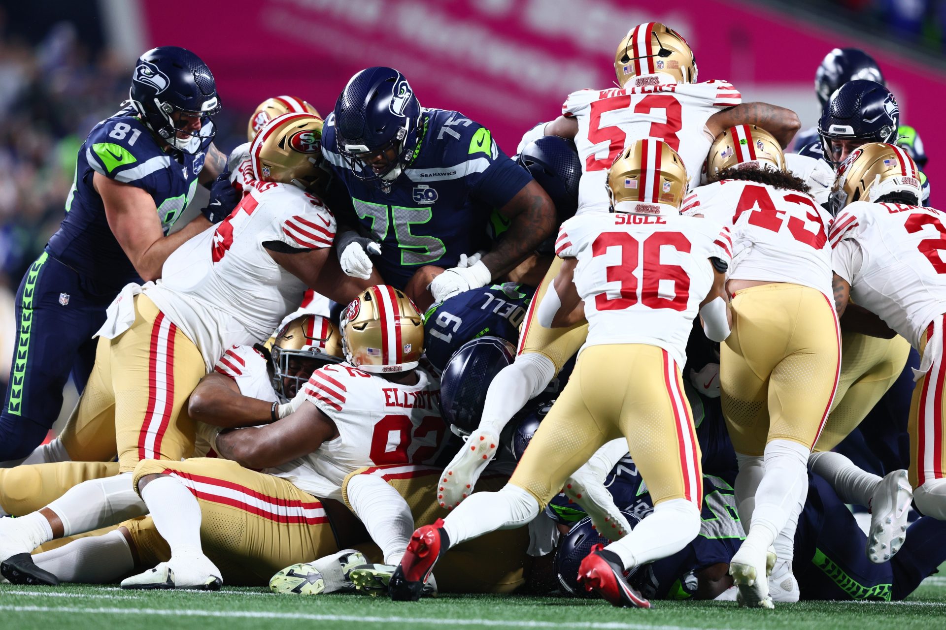 Jan 17, 2026; Seattle, WA, USA; Seattle Seahawks quarterback Sam Darnold (14) gets a first down on a “tush push” against the San Francisco 49ers during the first half in an NFC Divisional Round game at Lumen Field.