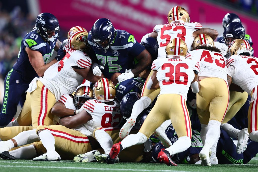 Jan 17, 2026; Seattle, WA, USA; Seattle Seahawks quarterback Sam Darnold (14) gets a first down on a “tush push” against the San Francisco 49ers during the first half in an NFC Divisional Round game at Lumen Field.