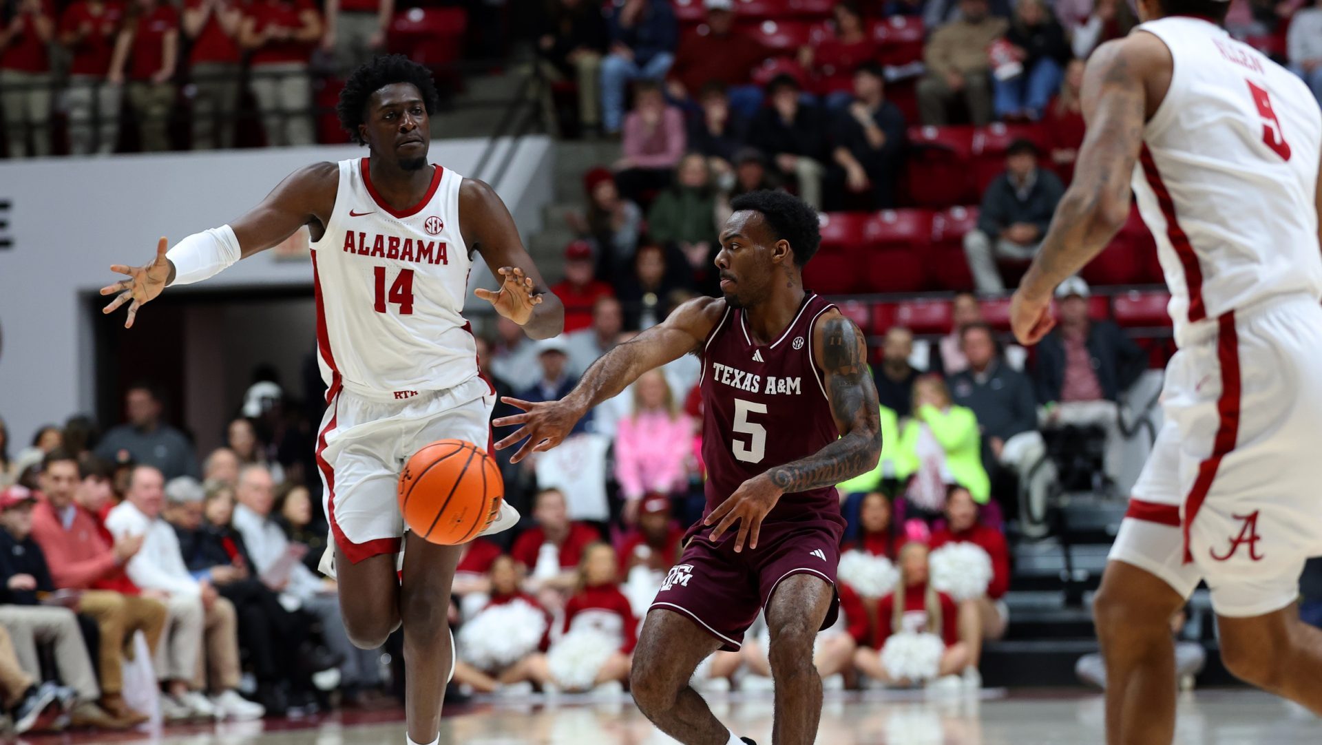 Feb 4, 2026; Tuscaloosa, Alabama, USA; Texas A&M Aggies guard Jacari Lane (5) passes against Alabama Crimson Tide center Charles Bediako (14) during the first half at Coleman Coliseum.