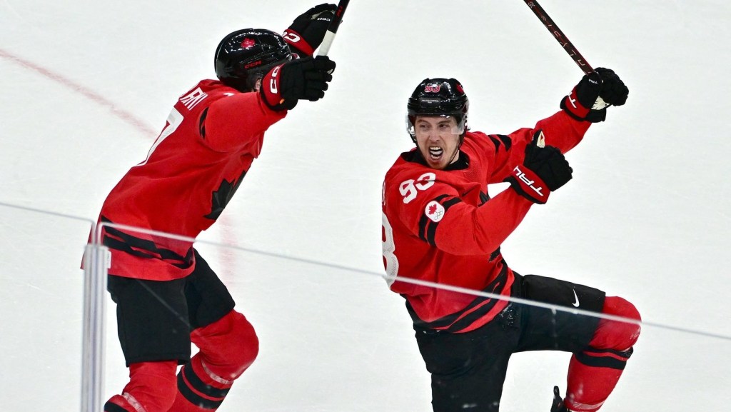 Feb 18, 2026; Milan, Italy; Mitch Marner of Canada celebrates with Macklin Celebrini after scoring their fourth goal in overtime to win the match against Czechia in a men's ice hockey quarterfinal during the Milano Cortina 2026 Olympic Winter Games at Milano Santagiulia Ice Hockey Arena.