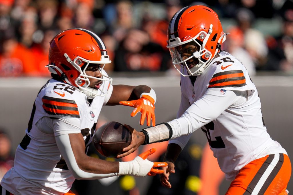 Cleveland Browns quarterback Shedeur Sanders (12) hands off to running back Dylan Sampson (22) in the first quarter of the NFL Week 18 game between the Cincinnati Bengals and the Cleveland Browns at Paycor Stadium in Downtown Cincinnati on Sunday, Jan. 4, 2026.