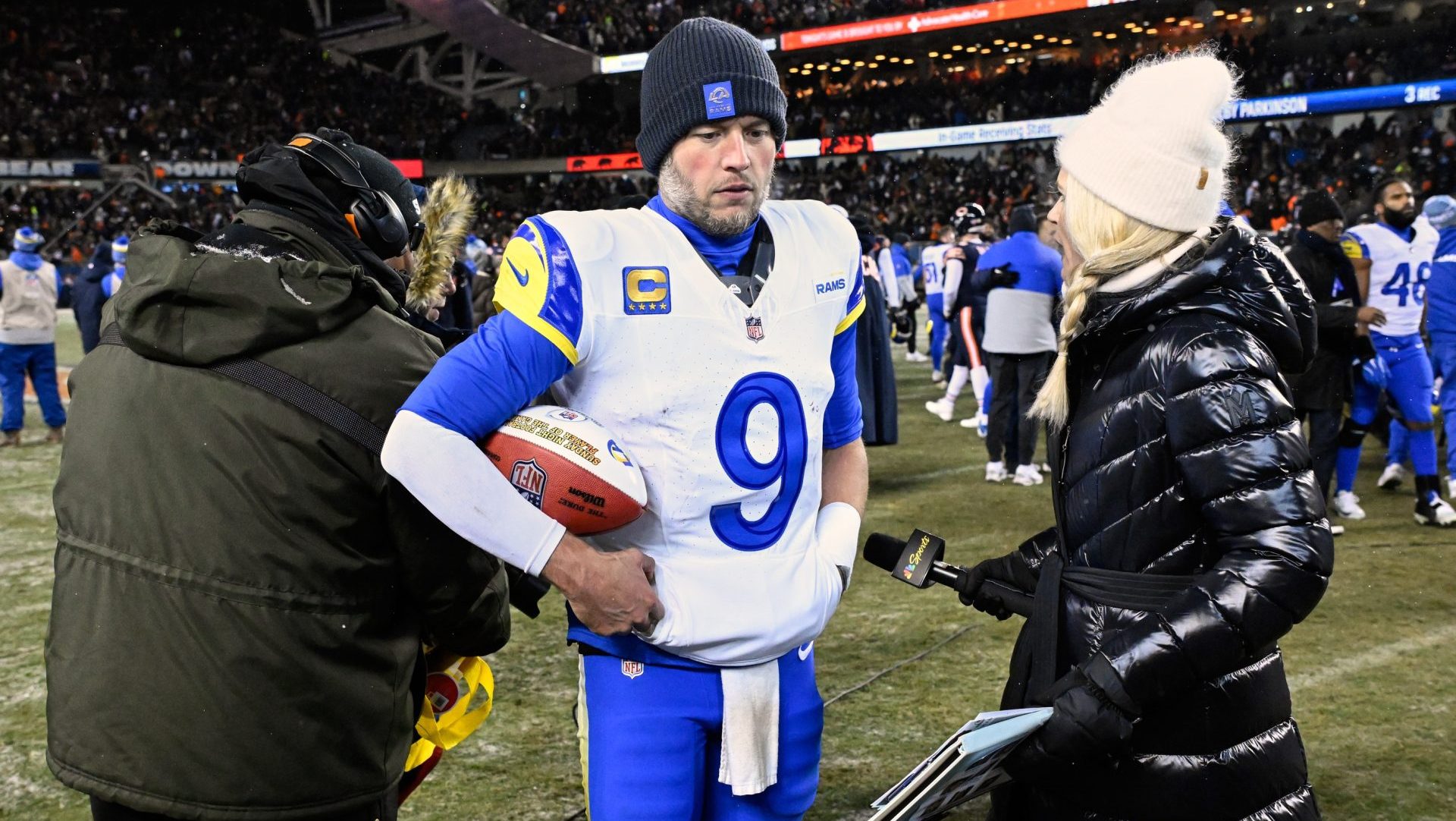 Jan 18, 2026; Chicago, IL, USA; Los Angeles Rams quarterback Matthew Stafford (9) holds a game ball as he is interviewed by NBC sideline reporter Melissa Stark after a NFC Divisional Round game against the Chicago Bears at Soldier Field. Mandatory Credit: Matt Marton-Imagn Images