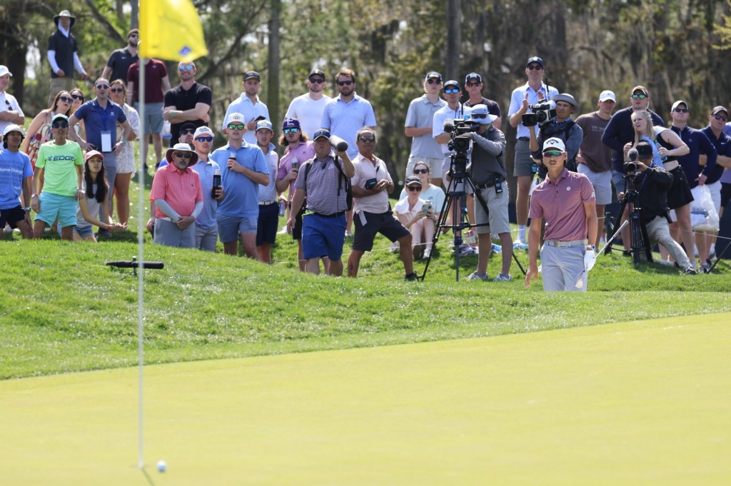 Min Woo Lee watches his chip from a bunker on on the fourth hole during the third round of The Players Championship PGA golf tournment Saturday, March 15, 2025 at TPC Sawgrass in Ponte Vedra Beach, Fla.