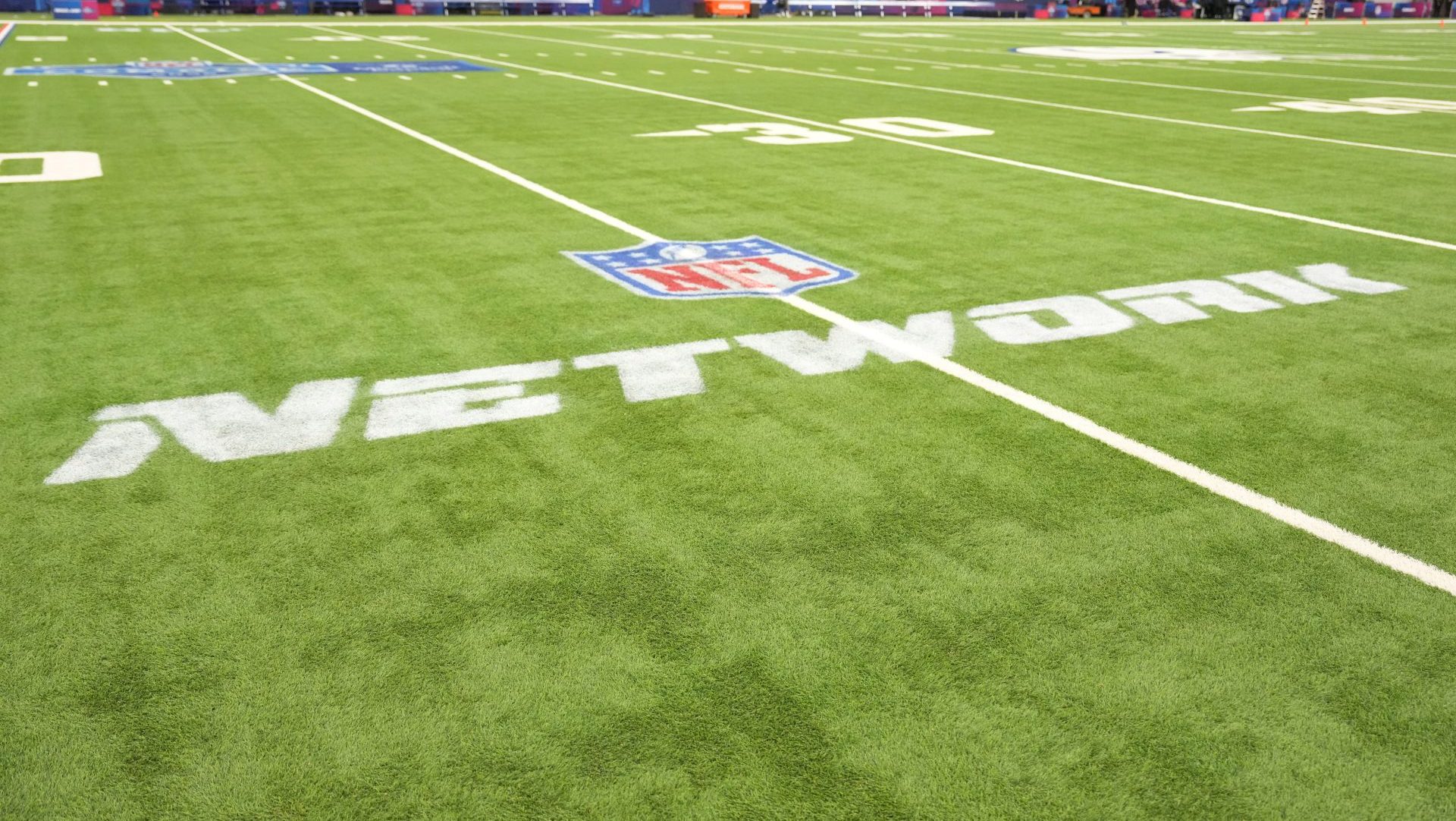 Feb 27, 2026; Indianapolis, IN, USA; The NFL Network logo on the field during the NFL Scouting Combine at Lucas Oil Stadium. Mandatory Credit: Kirby Lee-Imagn Images