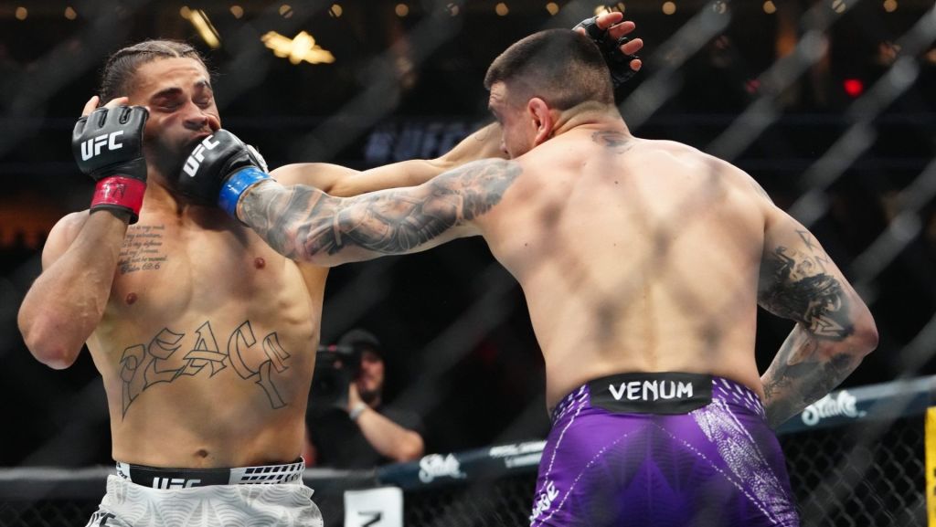 Mar 7, 2026; Las Vegas, Nevada, UNITED STATES; Donte Johnson (red gloves) fights Cody Brundage (blue gloves) during UFC 326 at T-Mobile Arena. Mandatory Credit: Stephen R. Sylvanie-Imagn Images