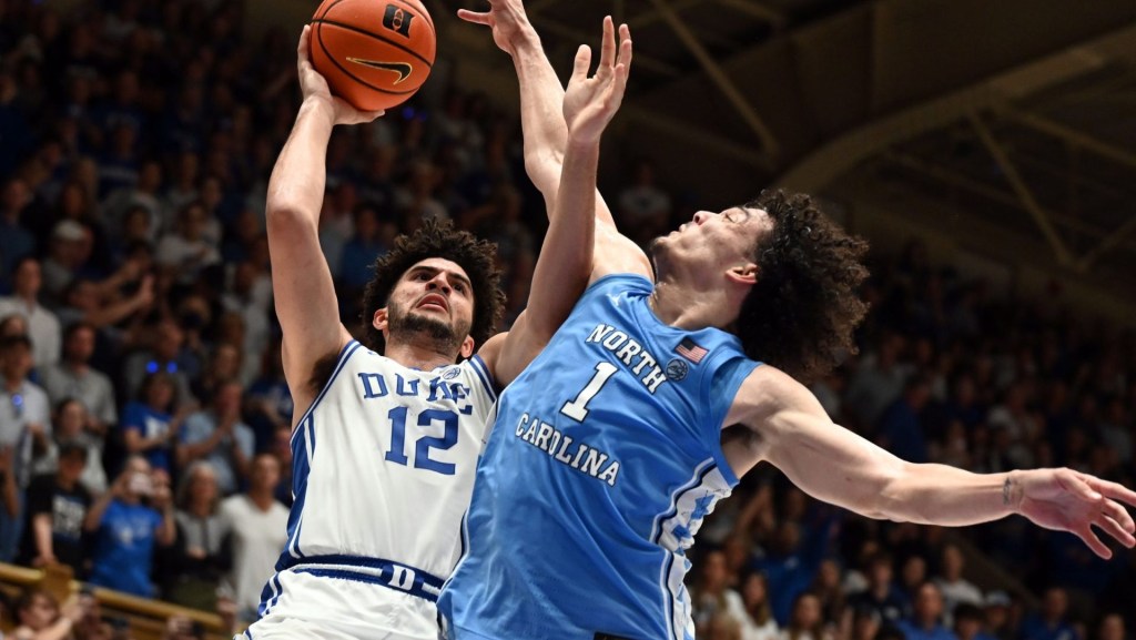 Mar 7, 2026; Durham, North Carolina, USA; Duke Blue Devils forward Cameron Boozer (12) shoots over North Carolina Tar Heels forward Zayden High (1) during the second half at Cameron Indoor Stadium. The Duke Blue Devils won 76-61.