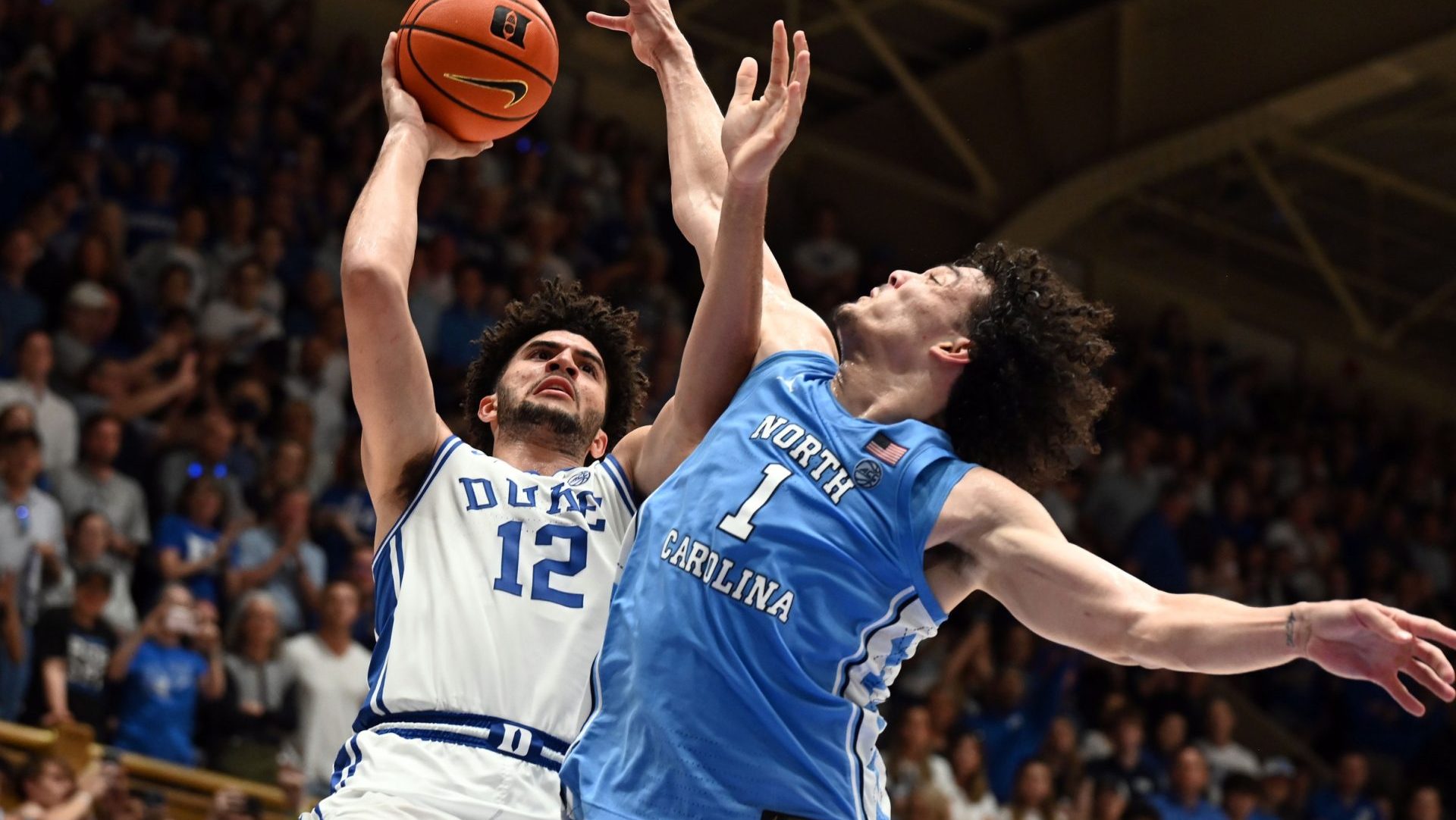 Mar 7, 2026; Durham, North Carolina, USA; Duke Blue Devils forward Cameron Boozer (12) shoots over North Carolina Tar Heels forward Zayden High (1) during the second half at Cameron Indoor Stadium. The Duke Blue Devils won 76-61.