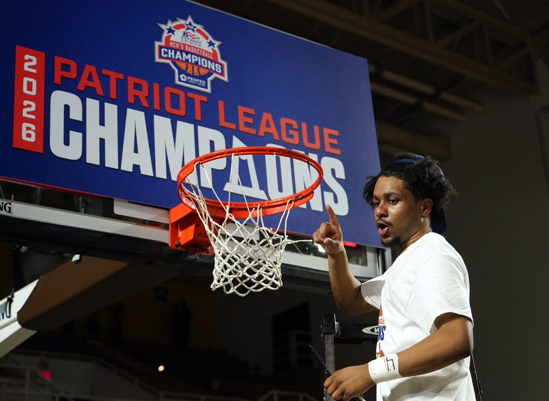 Mar 11, 2026; Bethlehem, Pennsylvania, USA; Lehigh Mountain Hawks guard Nasir Whitlock (1) cuts down the net after defeating the Boston University Terriers in the Patriot League Championship at Stabler Arena.