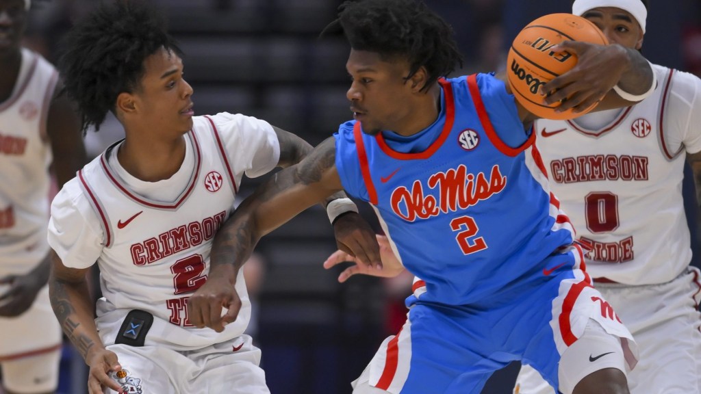 Mar 13, 2026; Nashville, TN, USA; Alabama Crimson Tide guard Aden Holloway (2) guards Mississippi Rebels guard AJ Storr (2) during the first half at Bridgestone Arena.