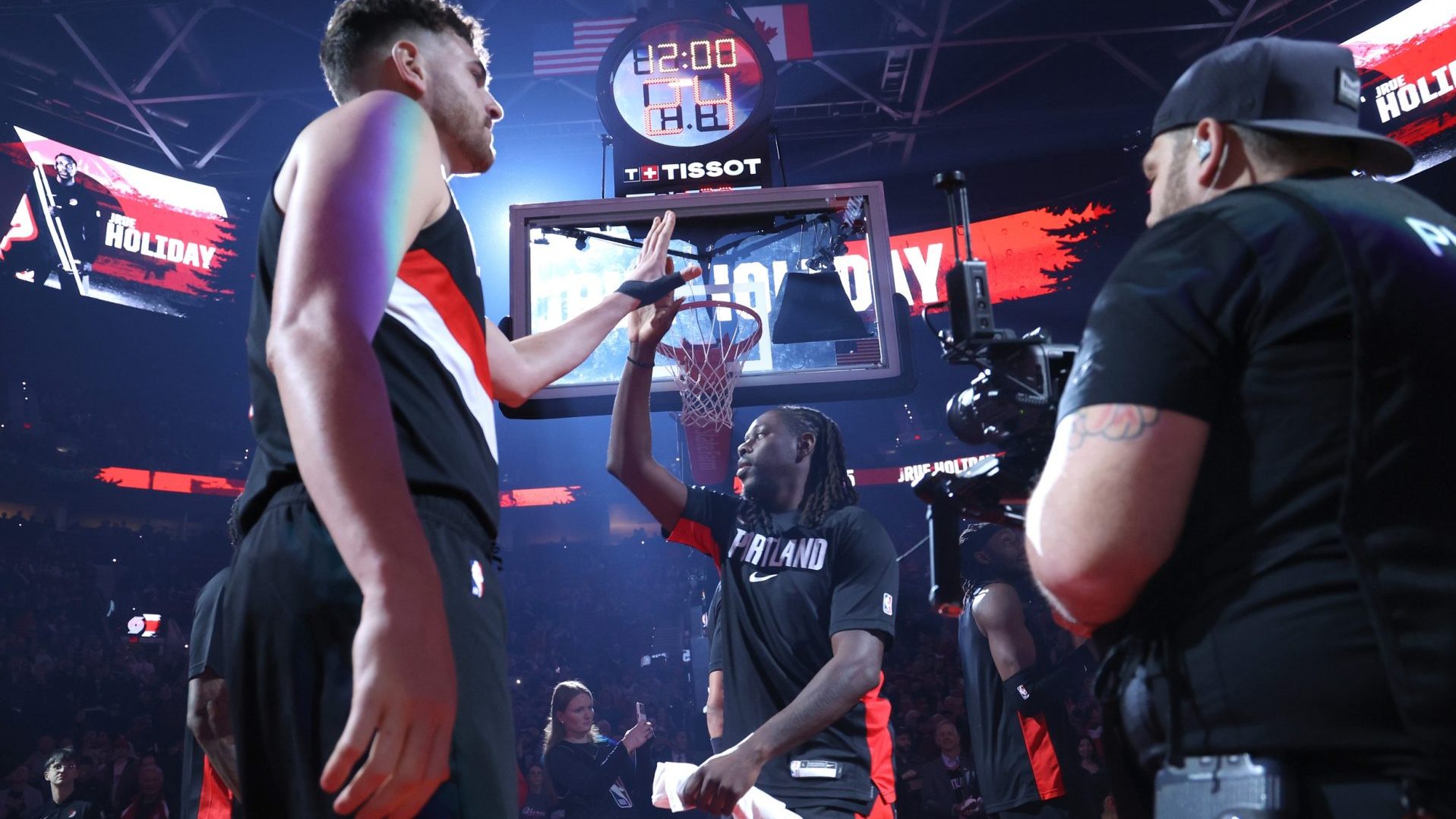 Mar 13, 2026; Portland, Oregon, USA; Portland Trail Blazers center Donovan Clingan (23) high-fives guard Jrue Holiday (5) while entering the line up to play against the Utah Jazz at Moda Center.