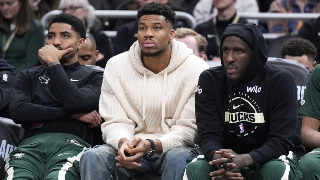 Mar 17, 2026; Milwaukee, Wisconsin, USA; Milwaukee Bucks guard Gary Harris (11), left, Milwaukee Bucks forward Giannis Antetokounmpo (34) and Milwaukee Bucks forward Taurean Prince (12) watch the game against the Cleveland Cavaliers from the bench in the second half at Fiserv Forum. Mandatory Credit: Michael McLoone-Imagn Images