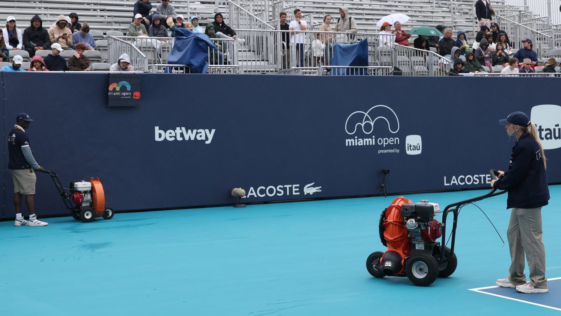 Mar 18, 2026; Miami Gardens, FL, USA; Workers dry Butch Buchholz Court during a rain delay on day 2 of the 2026 Miami Open at Hard Rock Stadium.