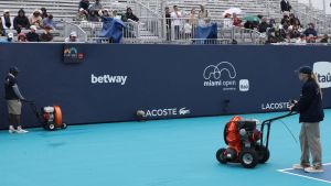 Mar 18, 2026; Miami Gardens, FL, USA; Workers dry Butch Buchholz Court during a rain delay on day 2 of the 2026 Miami Open at Hard Rock Stadium.