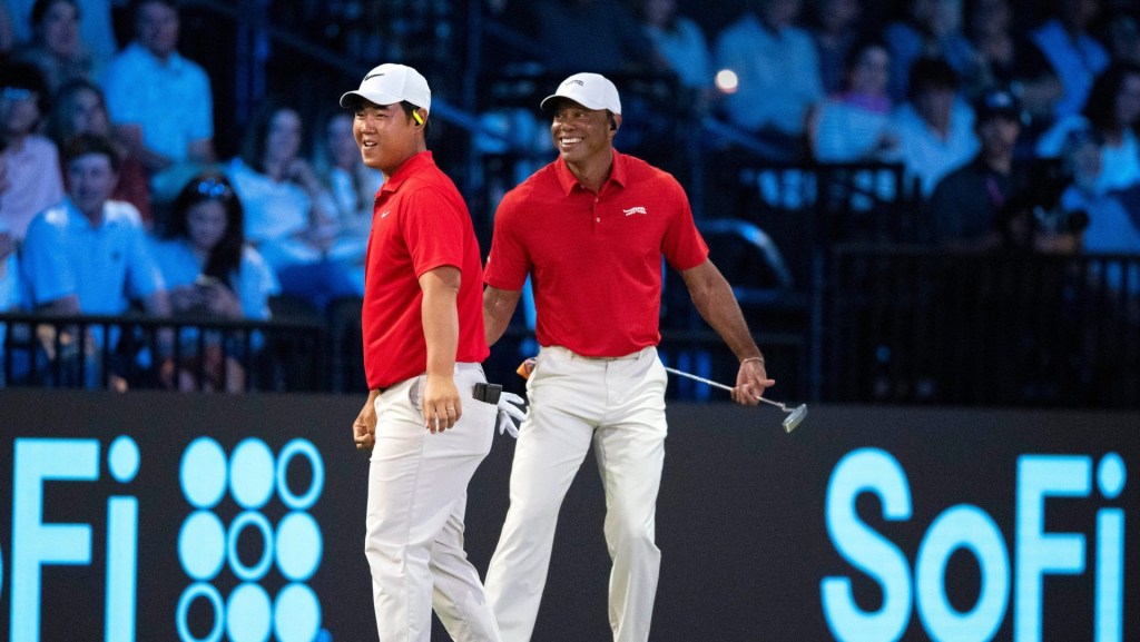 Tom Kim and Tiger Woods of Jupiter Links GC laugh during match against Los Angeles Golf Club during the TGL finals at SoFi Center on March 24, 2026, in Palm Beach Gardens, Florida.