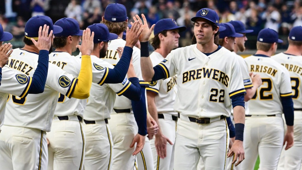 Mar 26, 2026; Milwaukee, Wisconsin, USA; Milwaukee Brewers designated hitter Christian Yelich (22) greets teammates during team introduction before Opening Day against the Chicago White Sox at American Family Field. Mandatory Credit: Benny Sieu-Imagn Images
