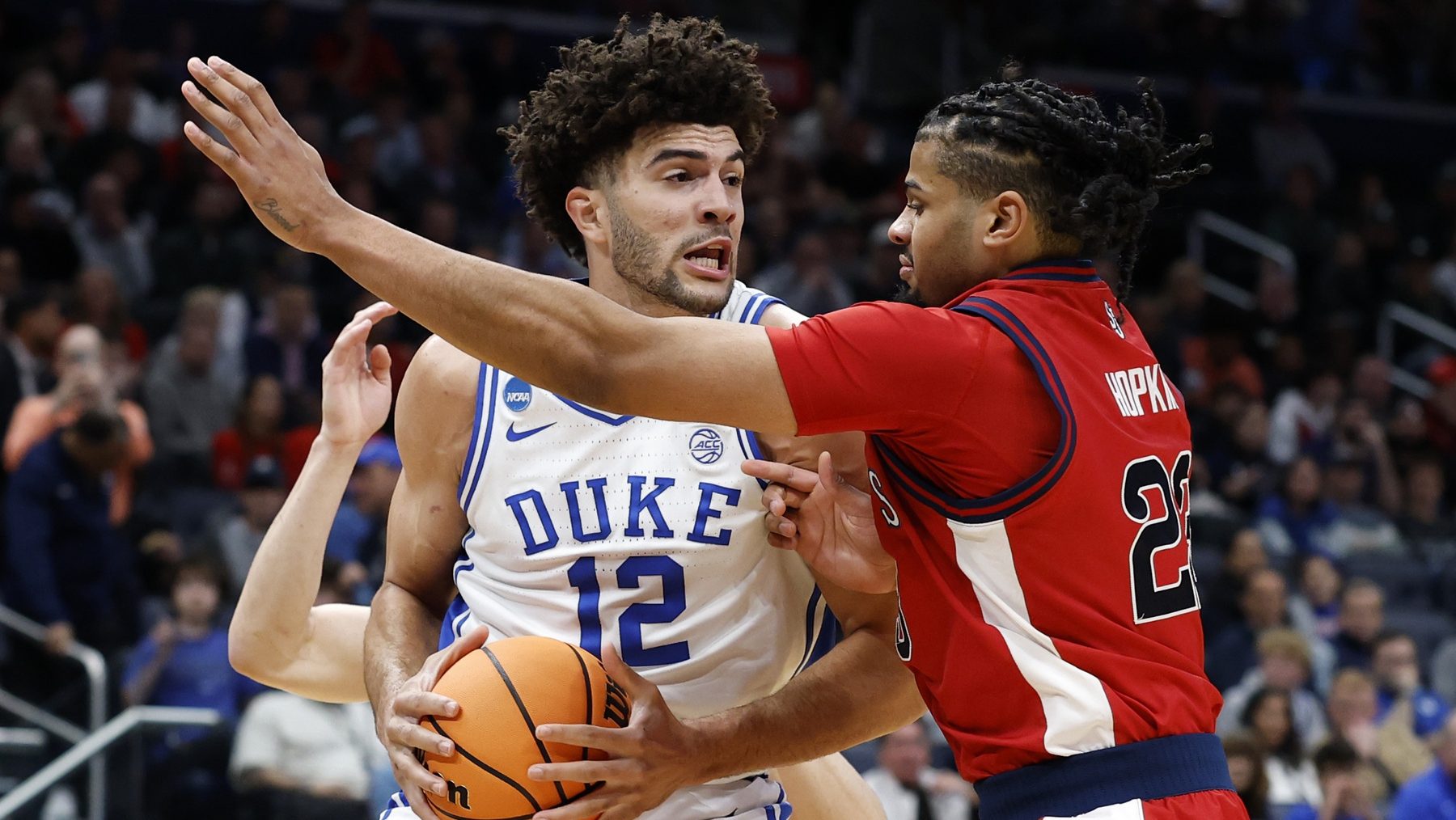 Mar 27, 2026; Washington, DC, USA; Duke Blue Devils forward Cameron Boozer (12) attempts to dribble the ball past St. John's Red Storm forward Bryce Hopkins (23) in the first half during a Sweet Sixteen game of the East Regional of the men's 2026 NCAA Tournament at Capital One Arena
