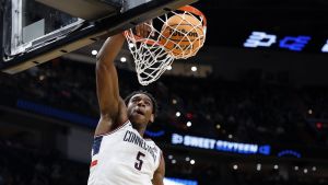 Mar 27, 2026; Washington, DC, USA;UConn Huskies forward Tarris Reed Jr. (5) dunks the ball against the Michigan State Spartans in the second half during a Sweet Sixteen game of the East Regional of the men's 2026 NCAA Tournament at Capital One Arena