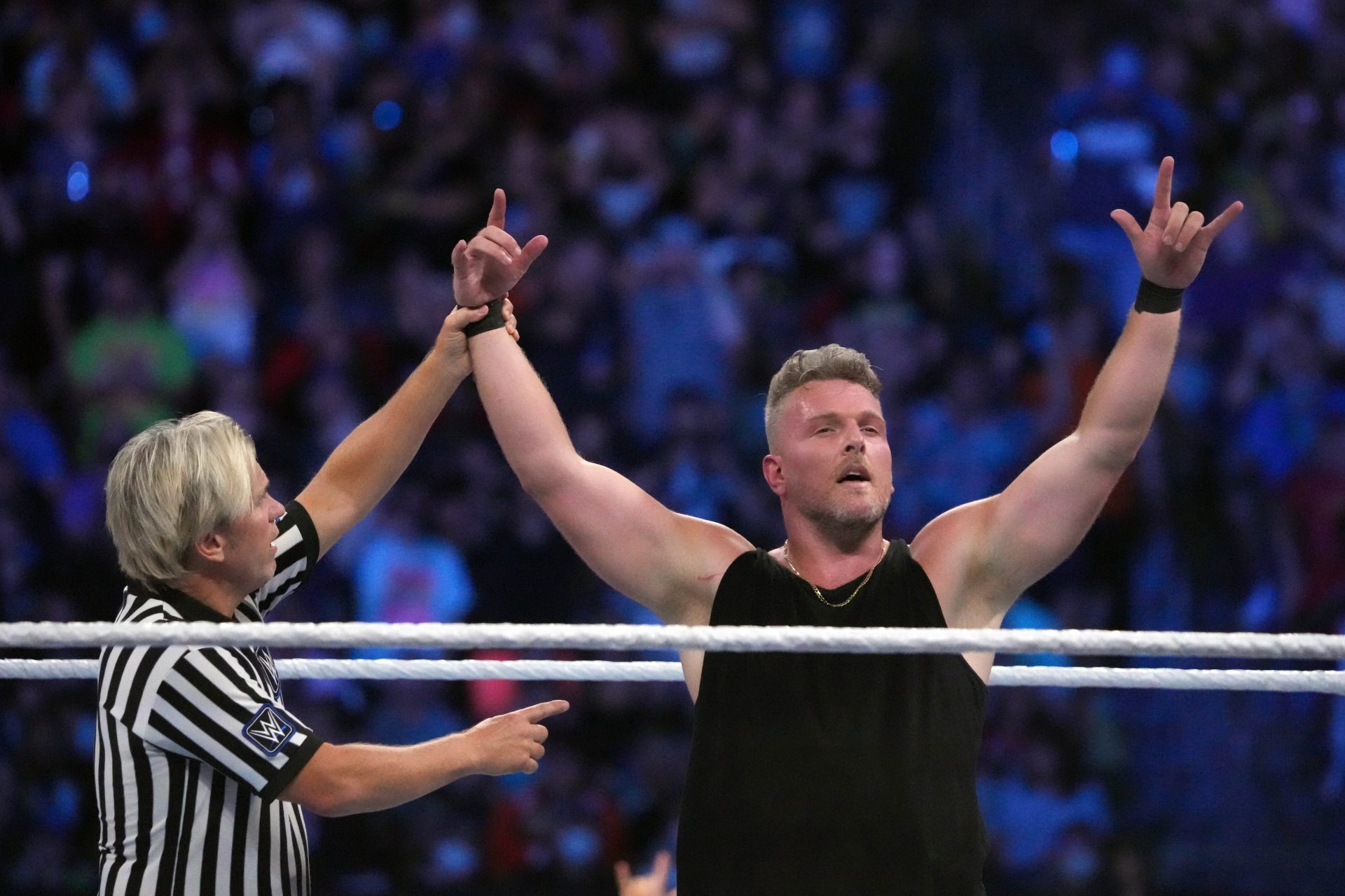 Jul 30, 2022; Nashville, Tennessee, US; Pat McAfee (black attire) and Happy Corbin (white/blue attire) wrestle during SummerSlam at Nissan Stadium.
