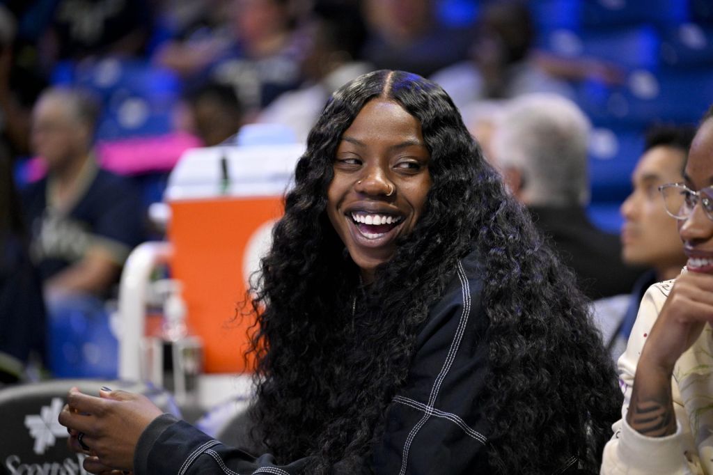 Aug 27, 2025; Arlington, Texas, USA; Dallas Wings guard Arike Ogunbowale (24) looks on from the team bench during the first half against the Connecticut Sun at College Park Center.