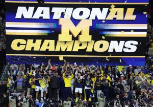 Apr 6, 2026; Indianapolis, IN, USA; Michigan Wolverines head coach Dusty May celebrates with the trophy after defeating the UConn Huskies in the national championship of the Final Four of the men's 2026 NCAA Tournament at Lucas Oil Stadium.