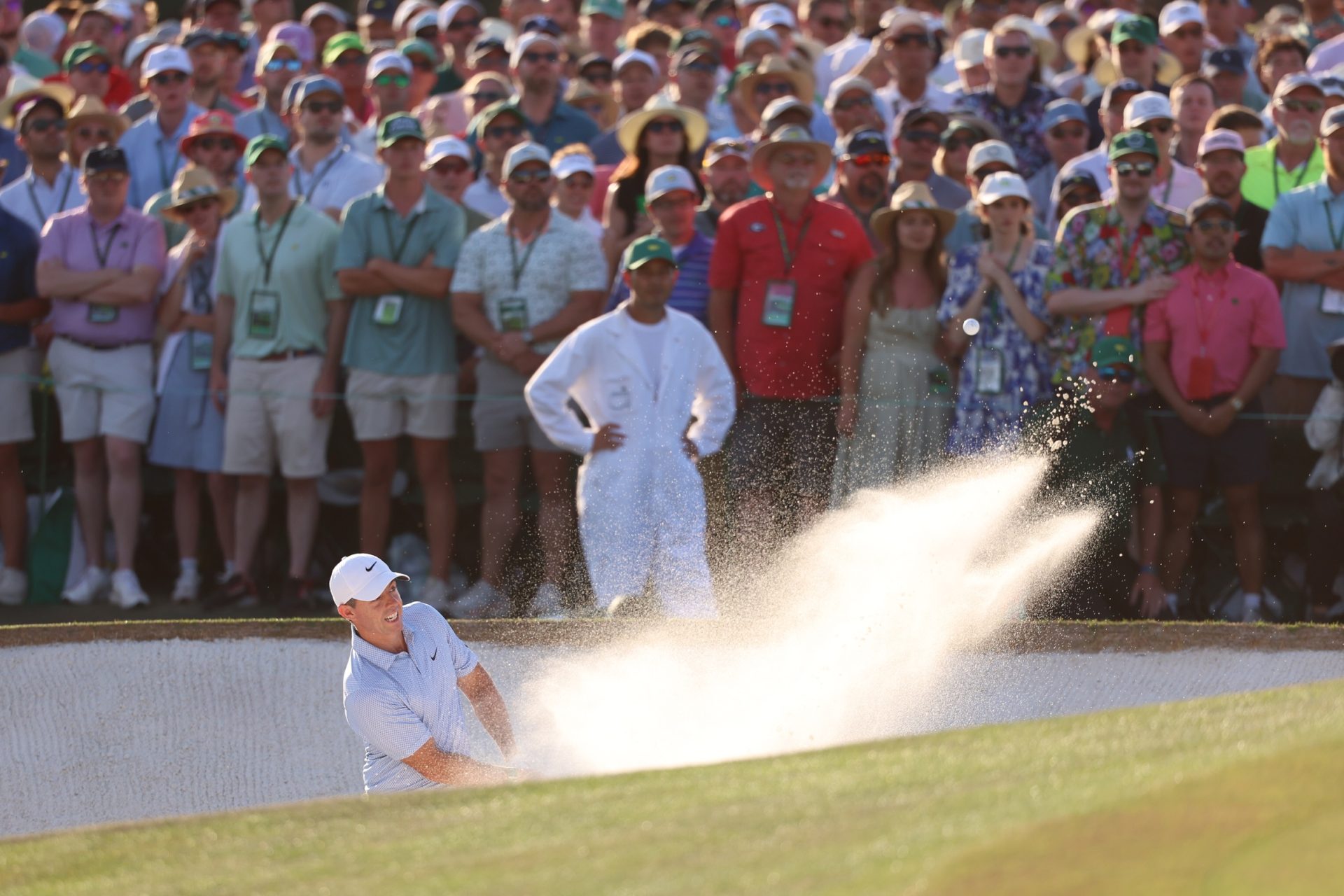 Apr 12, 2026; Augusta, Georgia, USA; Rory McIlroy plays a shot from a bunker on the 18th hole during the final round of the Masters Tournament at Augusta National Golf Club.