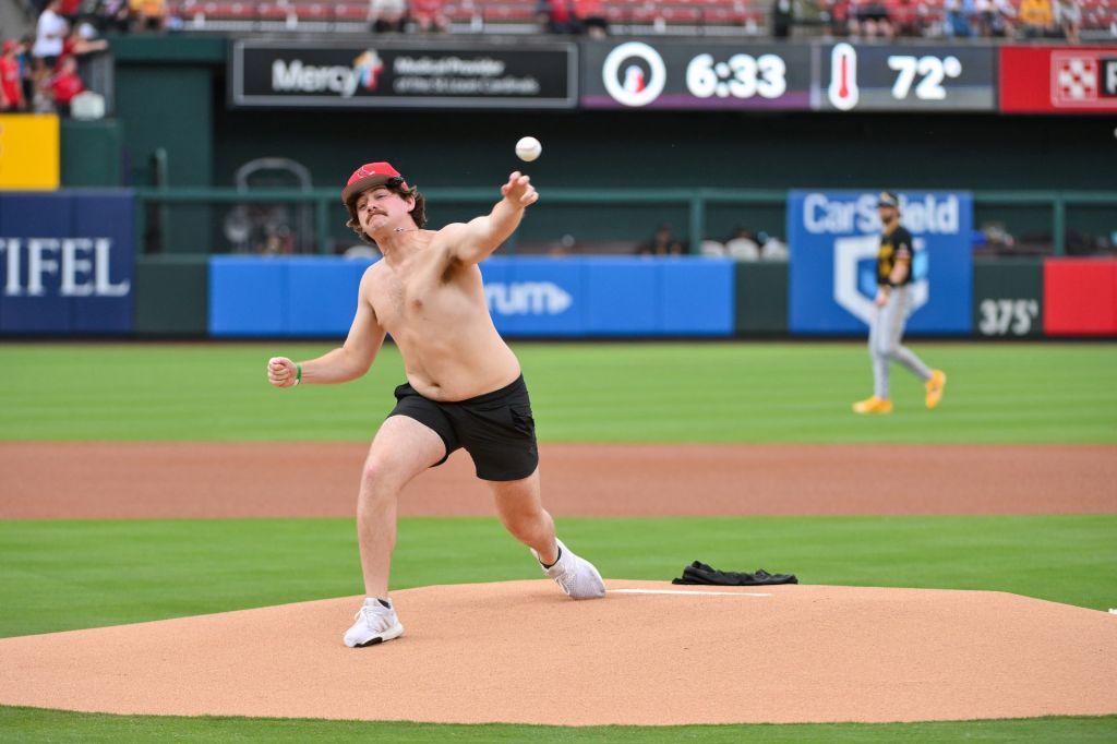 May 19, 2026; St. Louis, Missouri, USA; Stephen F. Austin Club baseball player Bryce Bradford who helped start the Tarps Off shirtless fan trend at Busch Stadium throws a ceremonial first pitch before a game between the St. Louis Cardinals and the Pittsburgh Pirates.