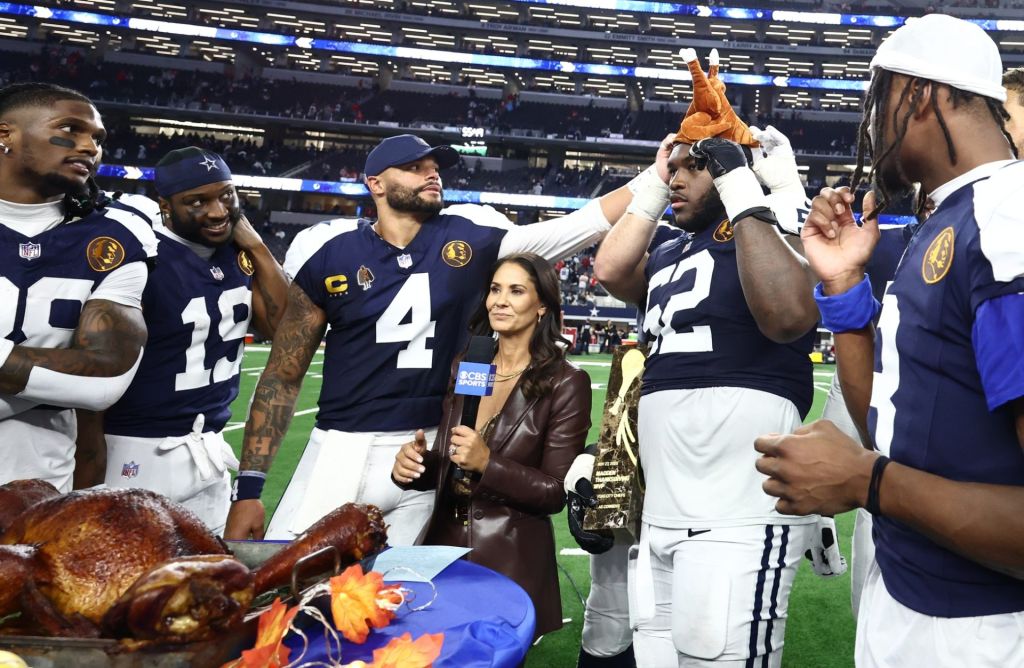 Nov 27, 2025; Arlington, Texas, USA; Dallas Cowboys quarterback Dak Prescott (4) and Dallas Cowboys guard Tyler Booker (52) celebrate with a turkey after the game against the Kansas City Chiefs at AT&T Stadium.