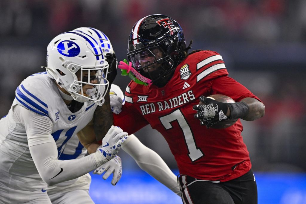Dec 6, 2025; Arlington, TX, USA; BYU Cougars safety Faletau Satuala (11) tackles Texas Tech Red Raiders tight end Terrance Carter Jr. (7) during the game between the Red Raiders and the Cougars at AT&T Stadium.