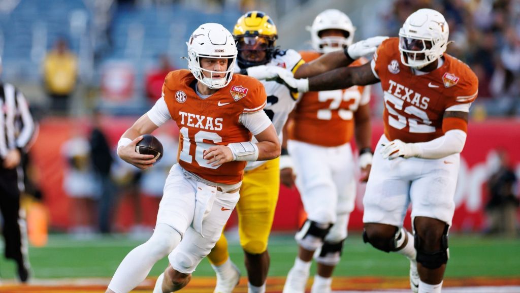 Dec 31, 2025; Orlando, FL, USA; Texas Longhorns quarterback Arch Manning (16) runs with the ball against the Michigan Wolverines during the first half at Camping World Stadium.