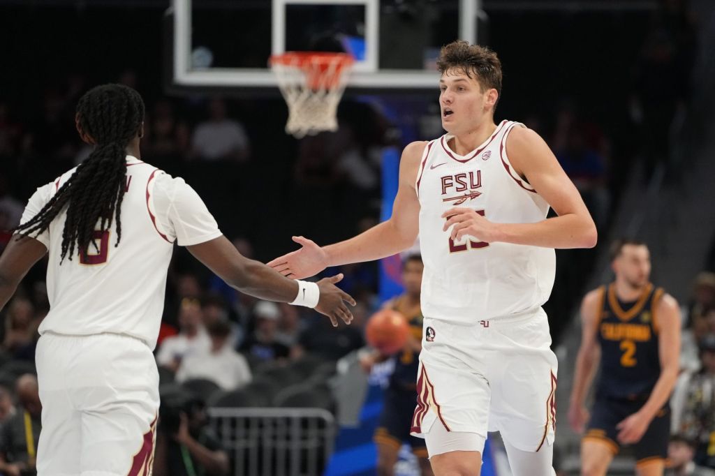 Mar 11, 2026; Charlotte, NC, USA; Florida State Seminoles forward Alex Steen (25) reacts with guard Robert McCray V. (6) in the first half at Spectrum Center.
