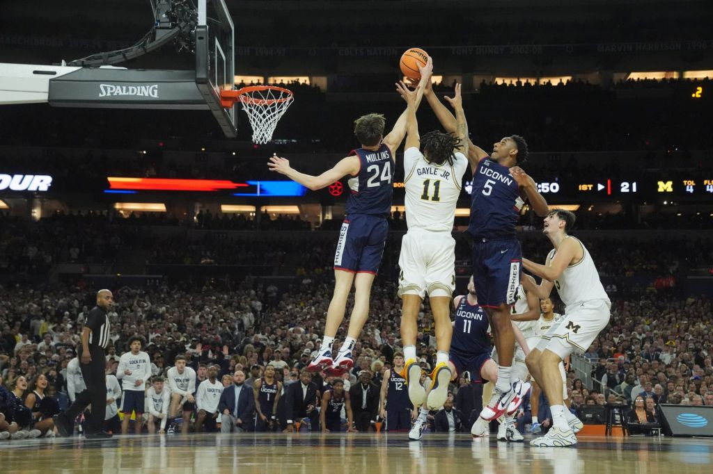Apr 6, 2026; Indianapolis, IN, USA; Michigan Wolverines guard Roddy Gayle Jr. (11) goes up for a rebound against Connecticut Huskies guard Braylon Mullins (24) and Connecticut Huskies forward Tarris Reed Jr. (5) in the first half during the national championship of the Final Four of the men's 2026 NCAA Tournament at Lucas Oil Stadium.