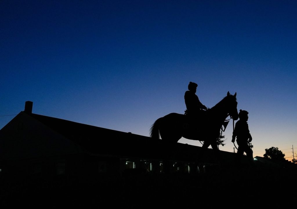The sun rises on the backside as horses work with their riders at Churchill Downs during Kentucky Derby week. April 30, 2026