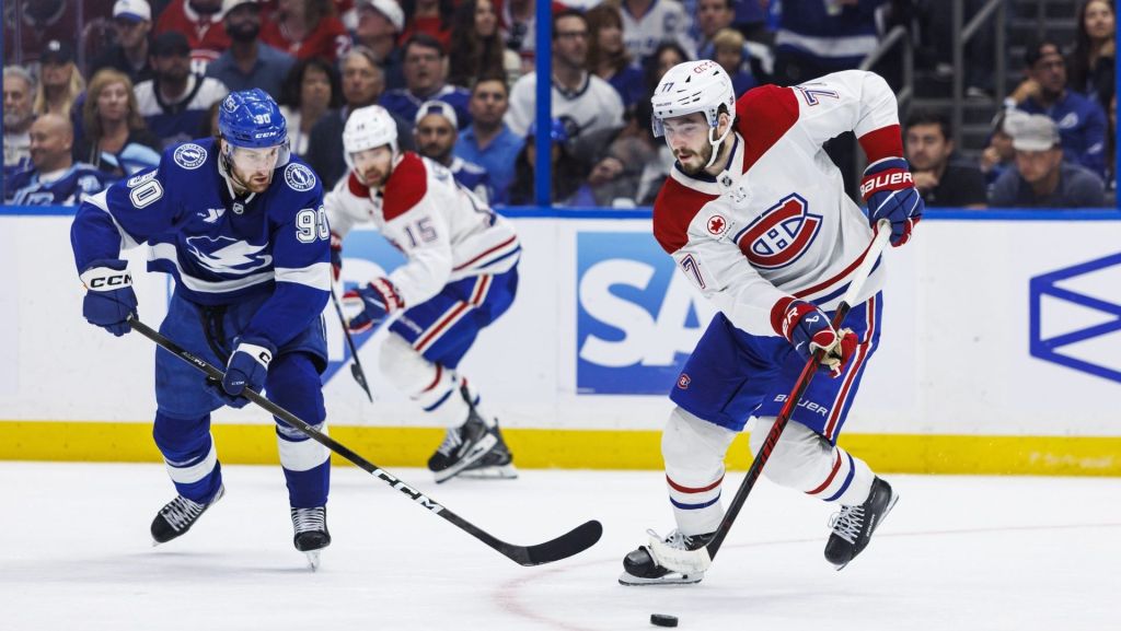 May 3, 2026; Tampa, Florida, USA; Tampa Bay Lightning defenseman J.J. Moser (90) and Montreal Canadiens forward Kirby Dach (77) chase the puck during the third period in game seven of the first round of the 2026 Stanley Cup Playoffs at Benchmark International Arena. Mandatory Credit: Morgan Tencza-Imagn Images
