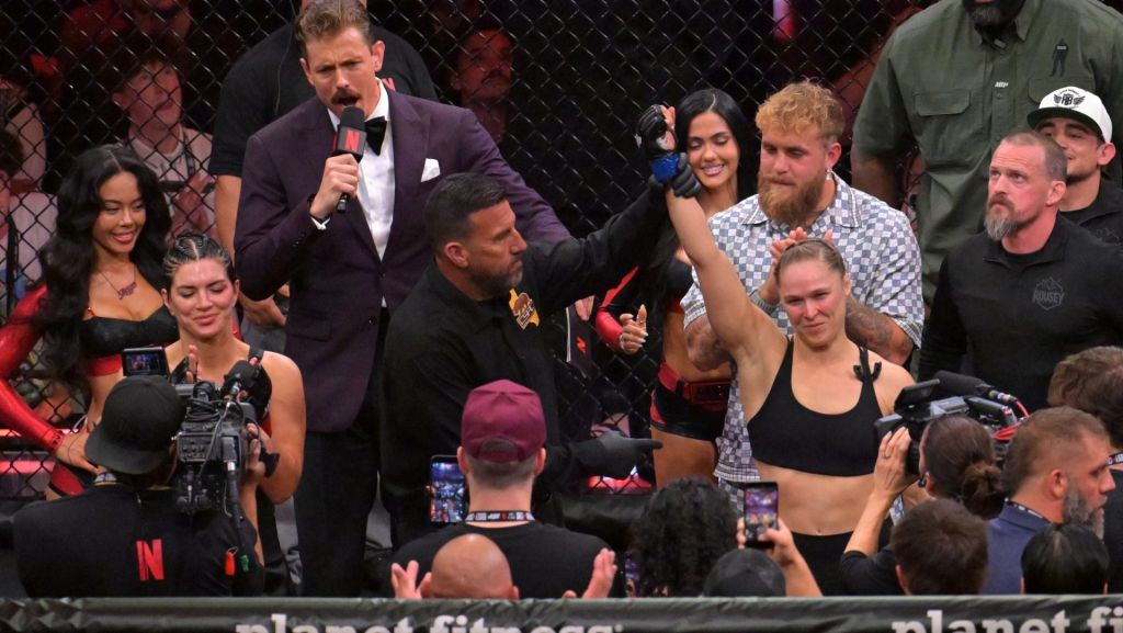 May 16, 2026; Los Angeles, California, USA; Ronda Rousey (blue gloves) celebrates defeating Gina Carano (red gloves) after a women's featherweight bout at Intuit Dome. Mandatory Credit: Jayne Kamin-Oncea-Imagn Images
