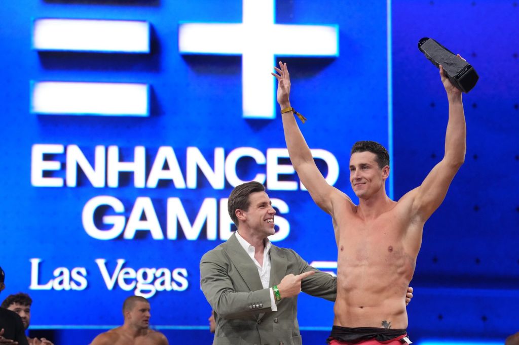 May 24, 2026; Las Vegas, NV, USA; Kristian Gkolomeev (GRE) poses with Enhanced co-founder Max Martin after setting a world record in the 50m freestyle of 21.81 during the Enhanced Games at Resorts World Las Vegas.