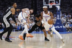 May 26, 2026; Oklahoma City, Oklahoma, USA; Oklahoma City Thunder guard Shai Gilgeous-Alexander (2) drives past San Antonio Spurs guard Stephon Castle (5) and Oklahoma City Thunder center Chet Holmgren (7) picks in front of San Antonio Spurs forward Keldon Johnson (3) during the third quarter in game five of the western conference finals for the 2026 NBA playoffs at Paycom Center.