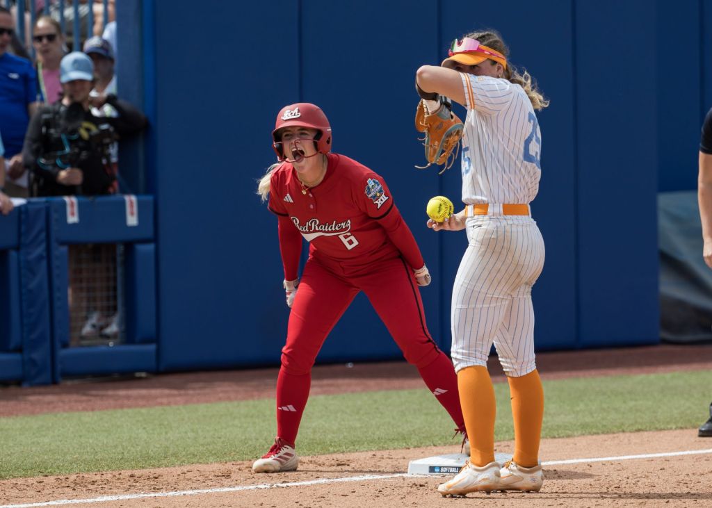 May 30, 2026; Oklahoma City, OK, USA; Texas Tech Red Raiders third baseman Taylor Pannell (6) yells towards her dugout after a stolen base as Tennessee Lady Volunteers infielder Ella Dodge (25) looks on in the seventh inning during the NCAA WomenÕs College World Series at Devon Park.