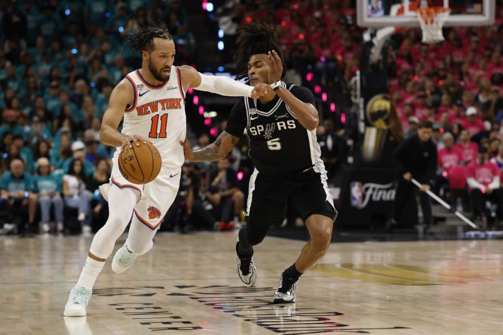 Jun 3, 2026; San Antonio, Texas, USA; New York Knicks guard Jalen Brunson (11) dribbles the ball past San Antonio Spurs guard Stephon Castle (5) in the first half during game one of the 2026 NBA Finals at Frost Bank Center.