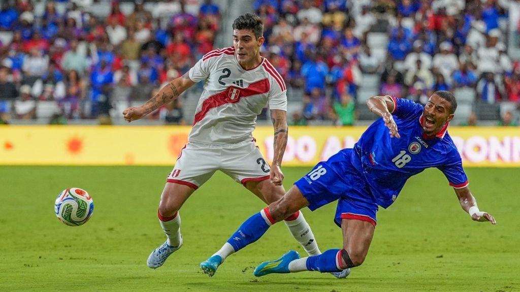 Jun 5, 2026; Miami, Florida, USA; Peru midfielder Alfonso Barca (2) battles for possession against Haiti forward Wilson Isidor (18) during the first half at Nu Stadium