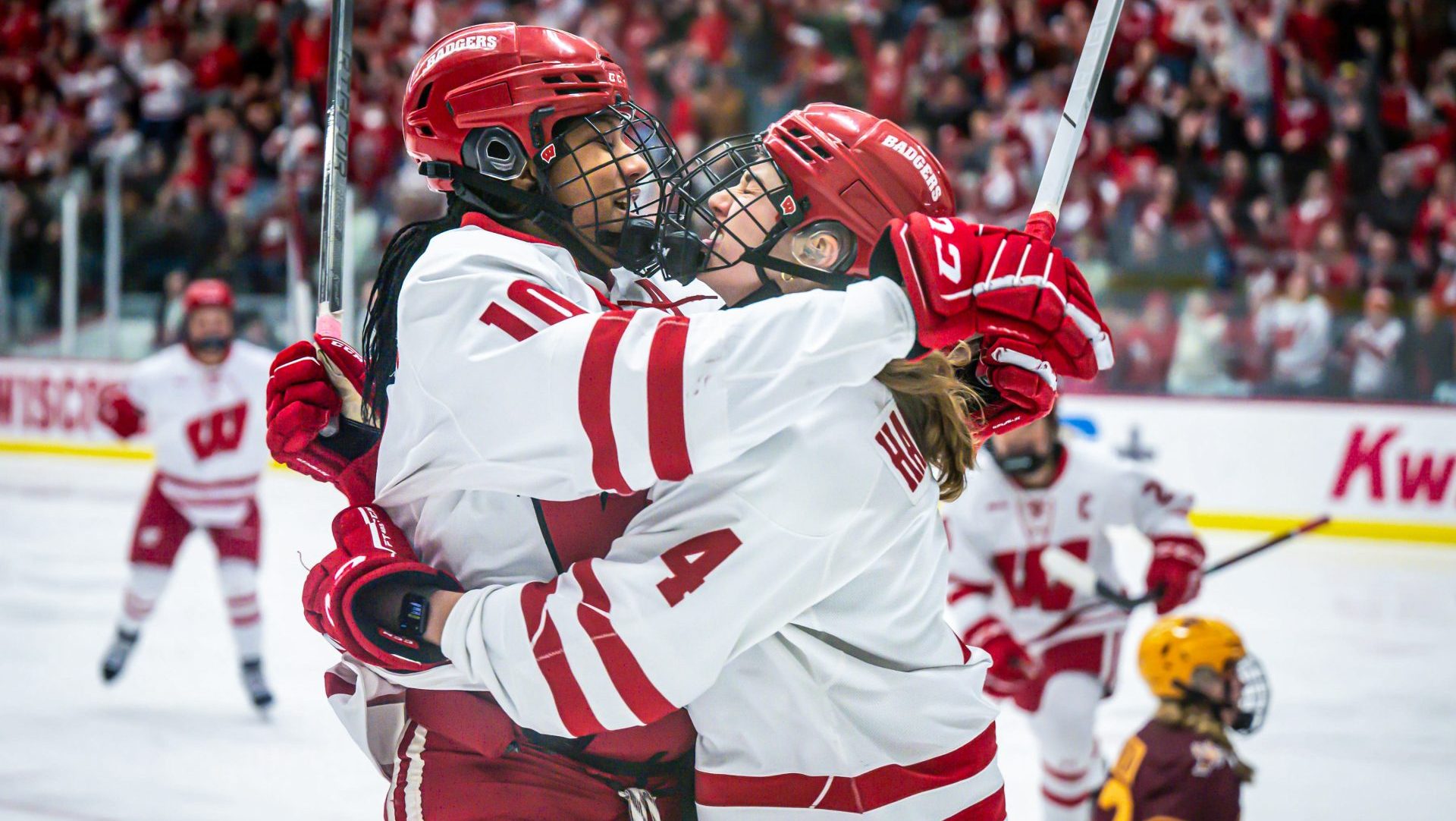 Wisconsin Badgers forward Laila Edwards, left, and defender Caroline Harvey celebrate after Edwards scored against the Minnesota Gophers in the first period in a game Saturday, February 8, 2025, at LaBahn Arena in Madison, Wisconsin.