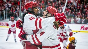 Wisconsin Badgers forward Laila Edwards, left, and defender Caroline Harvey celebrate after Edwards scored against the Minnesota Gophers in the first period in a game Saturday, February 8, 2025, at LaBahn Arena in Madison, Wisconsin.