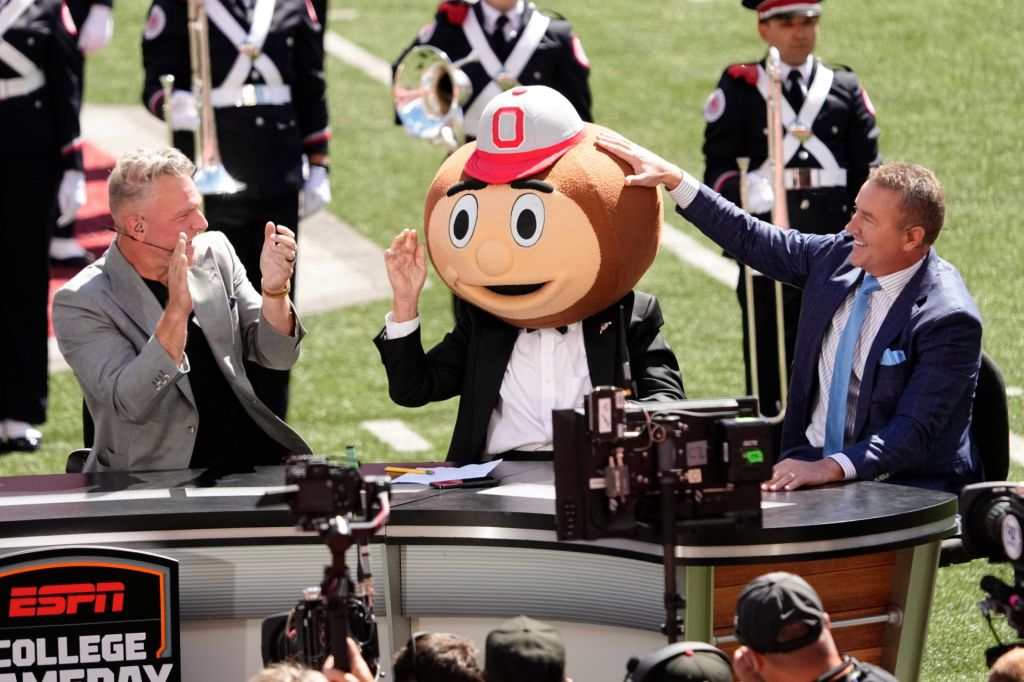 Lee Corso puts on the Brutus helmet as he makes his final pick between Kirk Herbstreit and Pat McAfee prior to the NCAA football game between the Ohio State Buckeyes and the Texas Longhorns at Ohio Stadium on Aug. 30, 2025.