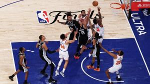 Jun 10, 2026; New York, New York, USA; New York Knicks forward OG Anunoby (8) makes a game-winning tip shot against San Antonio Spurs guards Dylan Harper (2) and Devin Vassell (24) during game four of the 2026 NBA Finals in the final second of the fourth quarter at Madison Square Garden. Mandatory Credit: Vincent Carchietta-Imagn Images