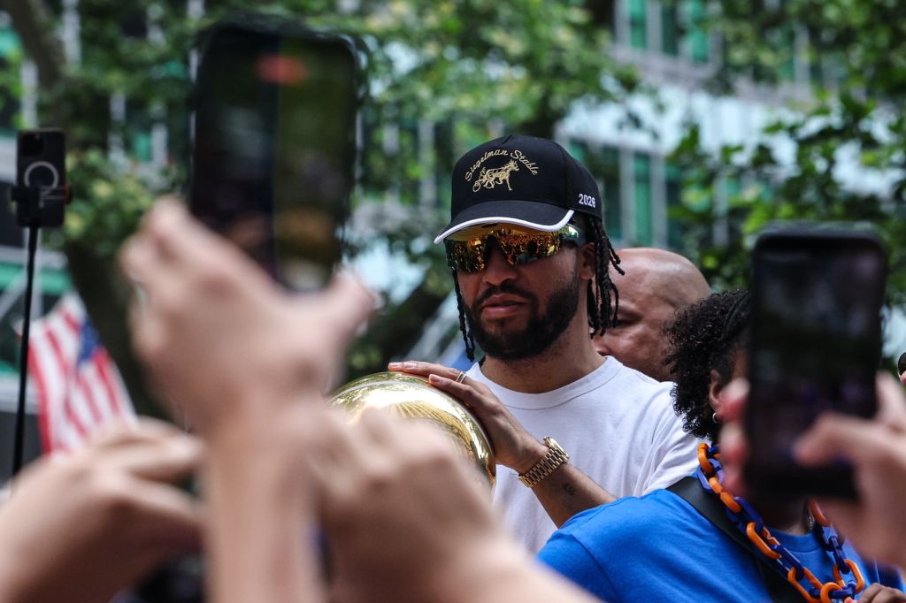 Jun 18, 2026; New York, NY, USA;  New York Knicks guard Jalen Brunson (11) holds the Larry O'Brien Championship Trophy during the Knicks ticker-tape parade and celebration
 on Broadway in downtown Manhattan. 
