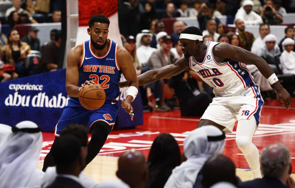 Basketball - NBA - New York Knicks v Philadelphia 76ers - Etihad Arena, Abu Dhabi, United Arab Emirates - October 4, 2025 New York Knicks' Karl-Anthony Towns in action with Philadelphia 76ers' Adem Bona